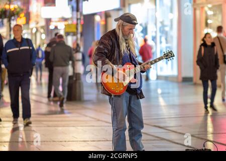 Belgrade / Serbia - September 25, 2018: Old rocker playing an electric guitar in pedestrian Knez Mihailo Street in central Belgrade, Serbia Stock Photo