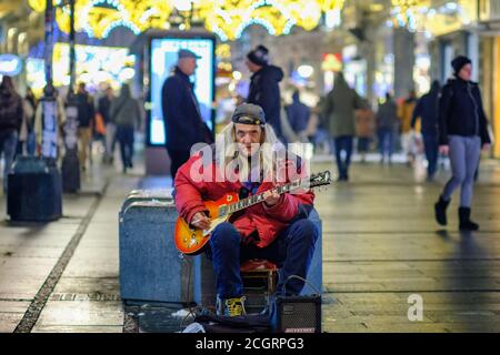 Belgrade / Serbia - December 20, 2018: Old rocker playing an electric guitar in pedestrian Knez Mihailo Street in central Belgrade, Serbia Stock Photo