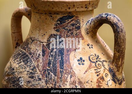 Vase from excavations in Mycenae, Greece. Painted archeological pottery, remains of Ancient Greek culture. Human image on terracotta ceramic, old Gree Stock Photo