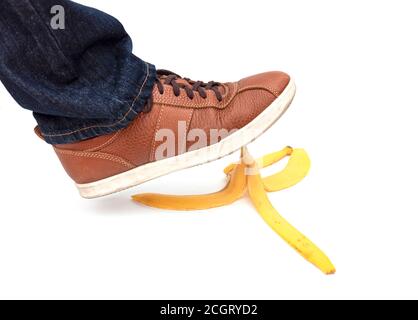 Leg of man stepping on banana peel, concept picture Stock Photo