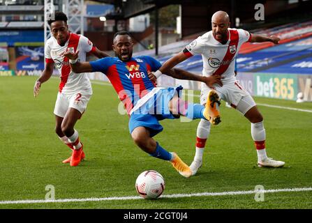 Crystal Palace's Jordan Ayew goes down under pressure from Southampton's Kyle Walker-Peters and Nathan Redmond during the Premier League match at Selhurst Park, London. Stock Photo