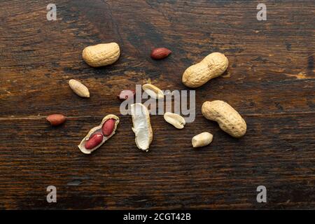Top view of Peanuts hulls nut shell and peeled peanuts on wooden background Stock Photo