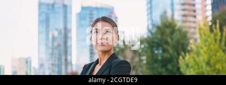 Asian confident business woman looking up to the bright future of her career opportunities. Job, work aspirational banner panorama background Stock Photo
