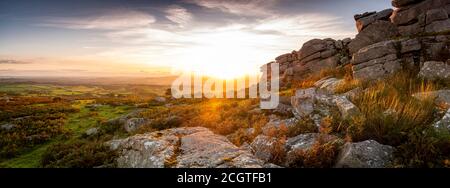 Sunset on Pew Tor on Dartmoor overlooking the Tamar Valley and Cornwall in the distance Stock Photo