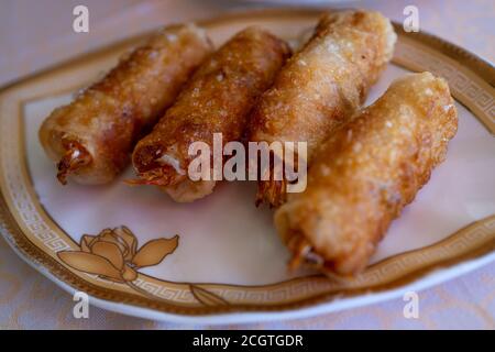 Fried spring rolls on light plate. Delicious Thai spring rolls.  Stock Photo