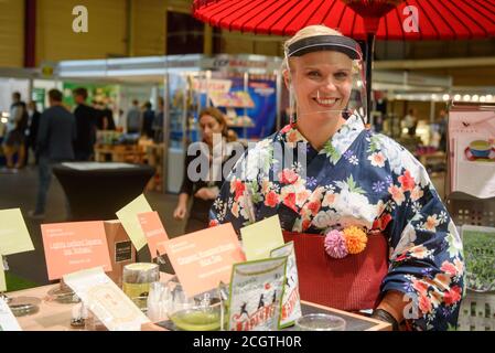 RIGA, LATVIA. 12th September 2020. Woman wearing japanese costume and face protective shield at Japan pavilion at International RIGA FOOD 2020 exhibition. Stock Photo