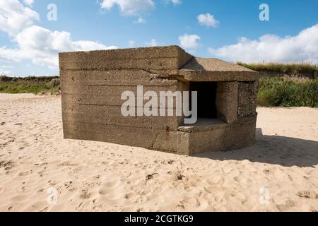 Old concrete pillbox on a beach Stock Photo