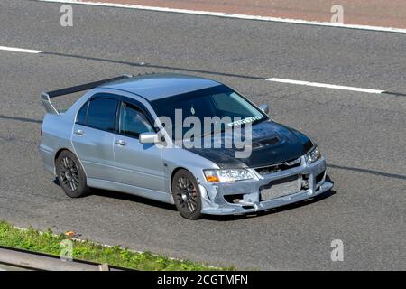 2003 modified blue Mitsubishi Lancer Evolution VIII; Vehicular traffic moving vehicles, cars driving vehicle on UK roads, motors, motoring on the M6 motorway highway network. Stock Photo