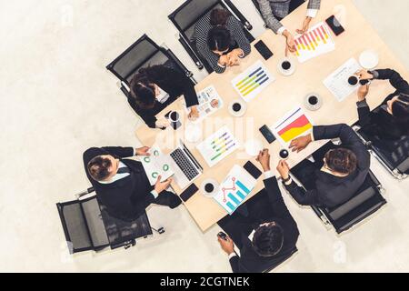 Business people group meeting shot from top view in office . Profession businesswomen, businessmen and office workers working in team conference with project planning document on meeting table . Stock Photo