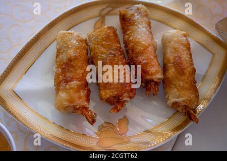 Fried spring rolls on light plate. Delicious Thai spring rolls.  Stock Photo