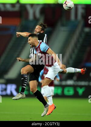 Newcastle United's Andy Carroll (left) and West Ham United's Ryan Fredericks battle for the ball during the Premier League match at London Stadium. Stock Photo