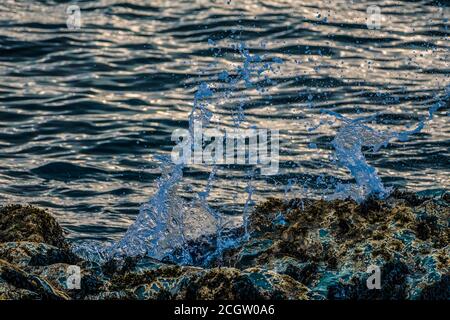 Sea wave splash over the rock Stock Photo
