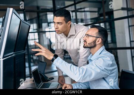Two traders analyzing stat and dynamic on forex charts Stock Photo