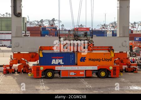 Gantry crane operator placing shipping containers on a automated transport vehicle in the Port of Rotterdam, The Netherlands, September 8, 2013. Stock Photo
