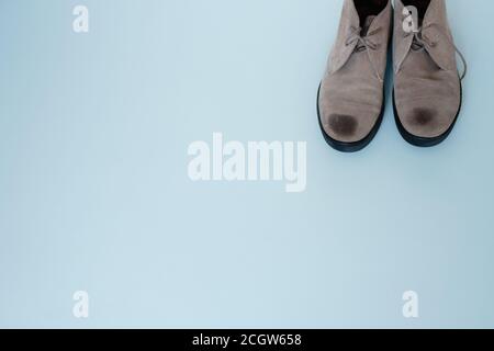pair of suede shoes on a gray background