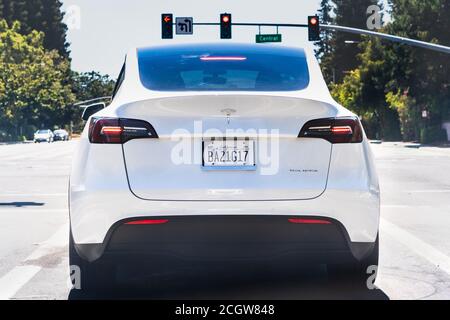 August 11, 2020 Sunnyvale / CA / USA - Tesla Model Y waiting at a traffic sign in Silicon Valley; San Francisco bay area Stock Photo