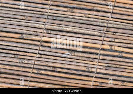 Flat lying section of natural reed garden screening, showing traces of early reed decay. Nice natural texture background or metaphor for gardening. Stock Photo