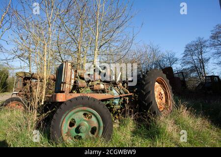 old farm vehicle left to decay outside Stock Photo