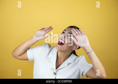 Beautiful woman over yellow background with a successful expression Stock Photo