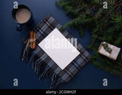 a sheet of paper lies on a table with a scarf and a cup of coffee Stock Photo