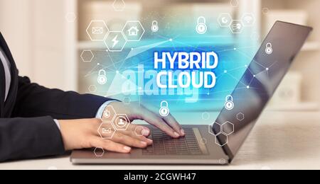 HYBRID CLOUD inscription on laptop, internet security and data protection concept, blockchain and cybersecurity Stock Photo