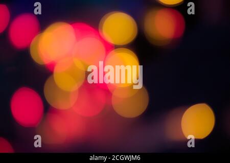Image of defocused circles of light in red and yellow colors with a dark background Stock Photo