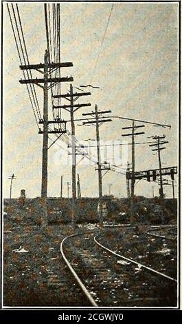 . Electric railway journal . e arms are practically what the name implies,two arms at the same elevation but on opposite sidesof the pole. Where they are placed at an angle theline of the two should split the angle unless a muchheavier pull is to be anticipated from one directionthan from the other, in which case the arms shouldsquare with this direction. Some Hints on Installing Double Crossarms The proper installation of double arms is not quiteas simple as it looks, but there are a few kinkswhich help very materially. The two arms are heldto the pole by the same bolt, which should be in the Stock Photo