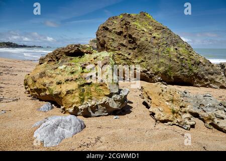 Big green stones on a sand beach. Atlantic coast in southwestern France Stock Photo