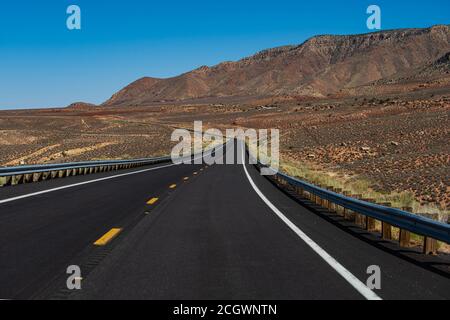 American roadtrip. Landscape with orange rocks, sky with clouds and asphalt road in summer. Stock Photo