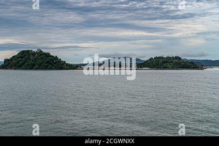 Panama City, Panama - November 30, 2008: Yacht harbor with tall ship between Flamenco and Perico green islands under multicolor cloudscape and behind Stock Photo