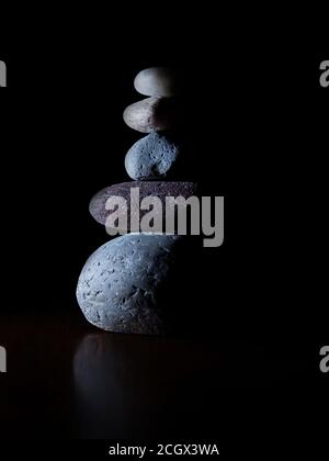 Stacked stones isolated on a black background. Stock Photo