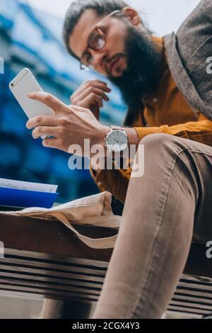Modern day young businessman checking his e-mail on a smart phone Stock Photo