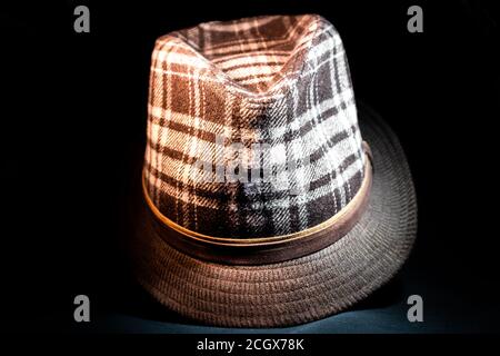 Old fashioned style fedora with modern pattern in darkness facing forward Stock Photo