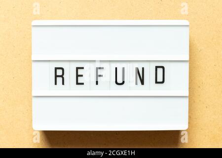 Lightbox with word refund on wood background Stock Photo