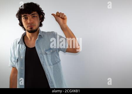 young hispanic deaf man using sign language to communicate, on a white background wearing casual clothes Stock Photo