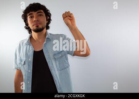young hispanic deaf man using sign language to communicate, on a white background wearing casual clothes Stock Photo