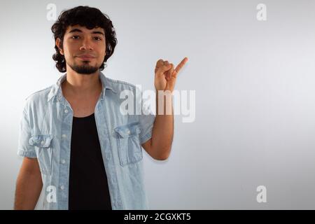 young hispanic deaf man using sign language to communicate, on a white background wearing casual clothes Stock Photo