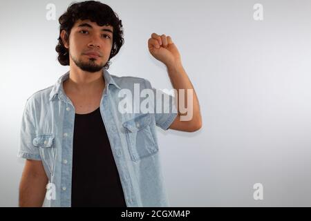 young hispanic deaf man using sign language to communicate, on a white background wearing casual clothes Stock Photo