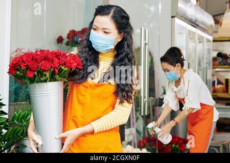 Florist in medical mask Stock Photo