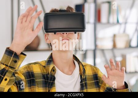 Teenager playing VR game Stock Photo