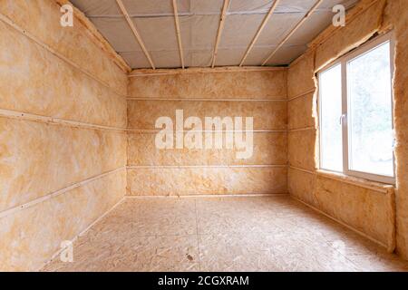 Roll insulation on the inner walls of a small room Stock Photo