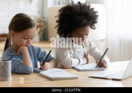 Little mixed race kids enjoying online educational class. Stock Photo