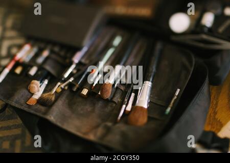 Makeup artist set. Close-up of a set of makeup brushes in a black cosmetic bag. Stock Photo