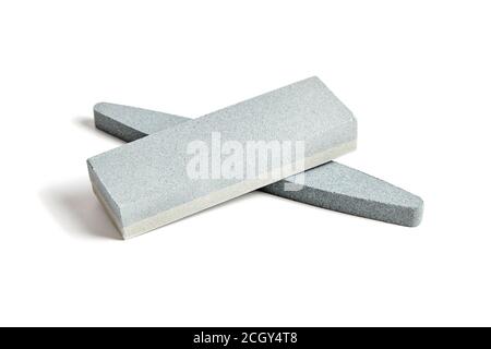 Two Sharpening stones. Grindstone or whetstone sharpener, isolated on white background. Kitchen utensils Stock Photo