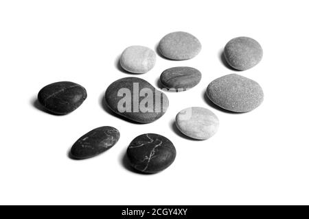 Pebbles, black and gray color smooth sea stones isolated on white background Stock Photo