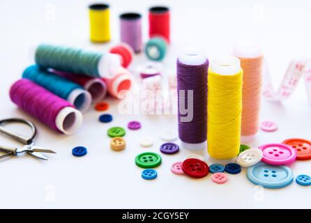 Color threads and sewing accessories on white background Stock Photo