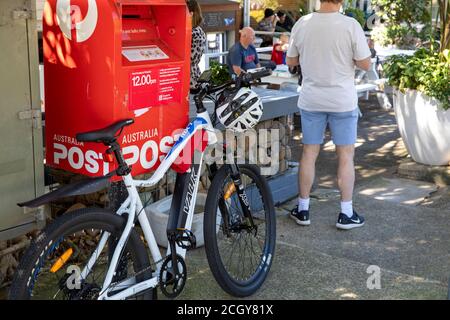 Valk hardcross electric e bike parked beside Australia Post mailbox in whale beach,Sydney,Australia Stock Photo