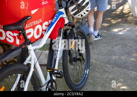 Valk hardcross electric e bike parked beside Australia Post mailbox in whale beach,Sydney,Australia Stock Photo