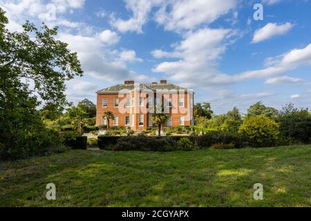 Side view of Hatchlands Park, a red-brick country house with surrounding gardens in East Clandon near Guildford, Surrey, south-east England Stock Photo
