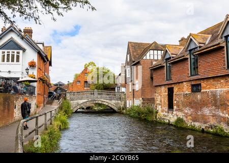 The River Itchen flowing through The Weirs in Winchester, Hampshire, south England viewed towards City Mill and the historic stone bridge Stock Photo